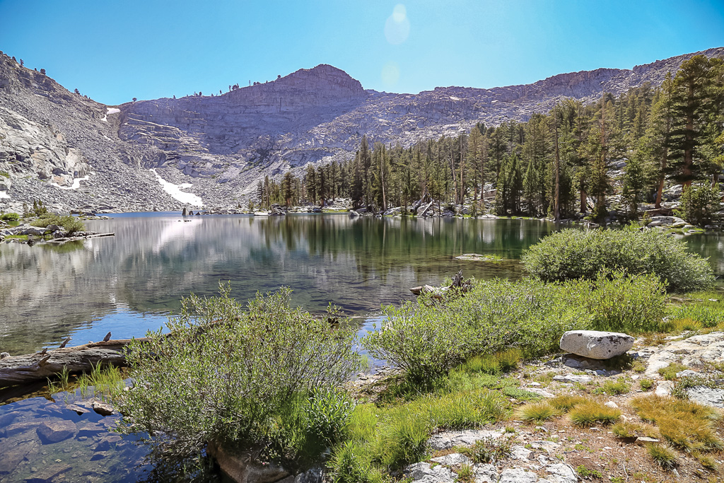 photo of eagle lakes with the sun shining and water reflection