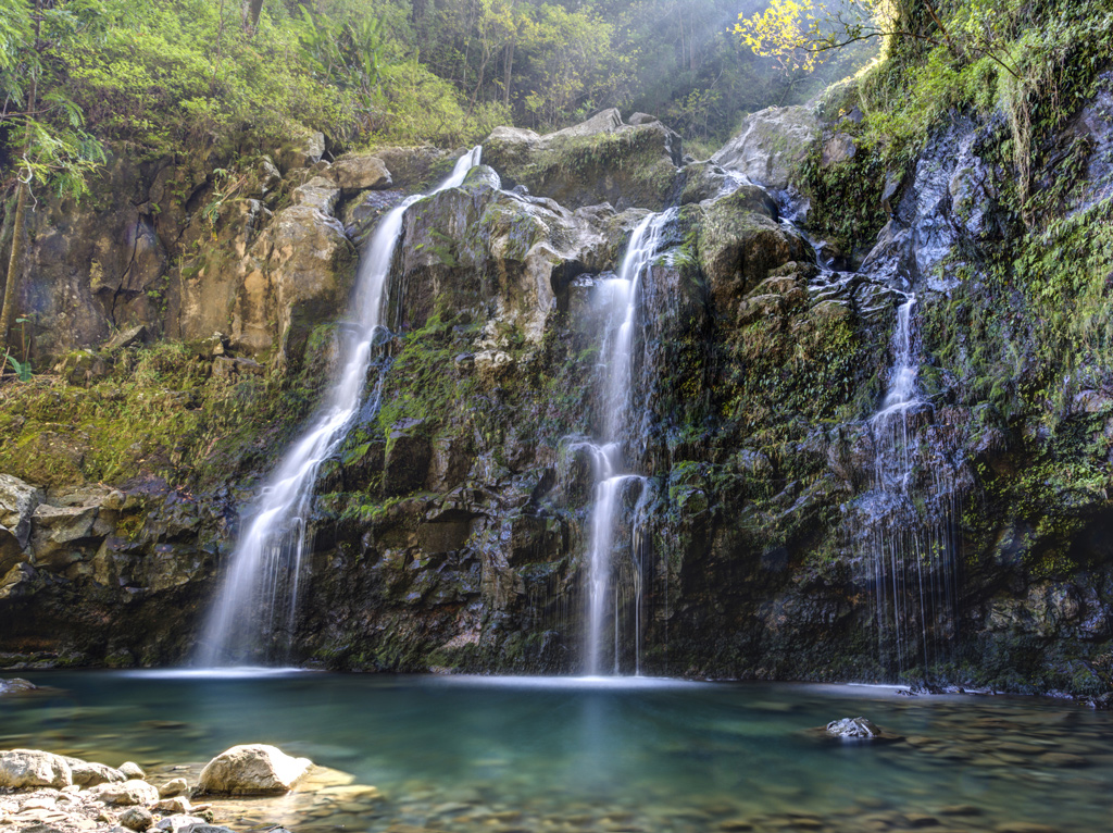 Tripple Waterfall called Upper Waikuni Falls or Three Bear Falls of the Wailua Nui Stream along the Road to Hana on Maui Island in Hawaii.