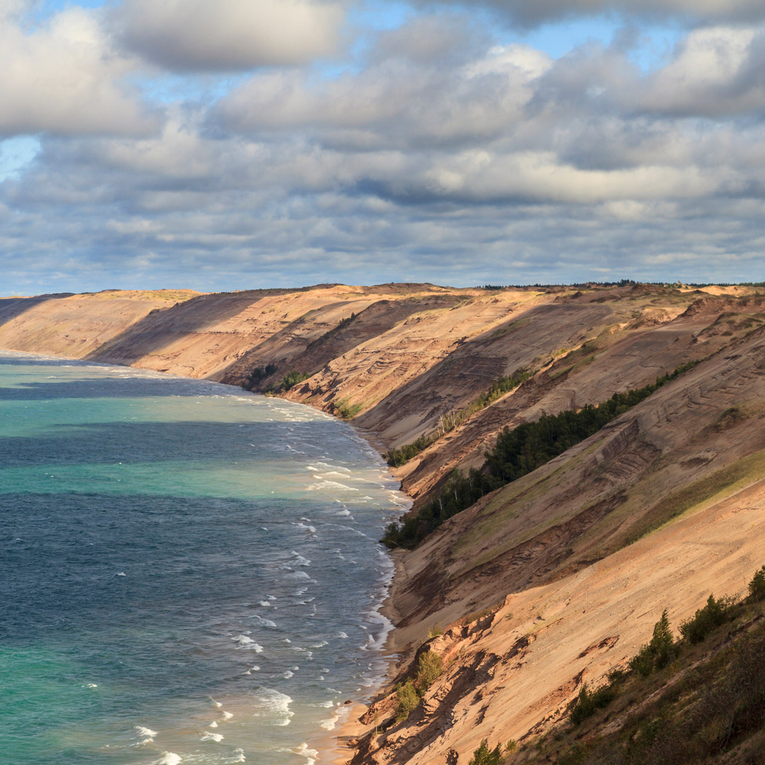 clouds gather and cast shadows over grand sable dunes in Pictured Rocks National Lakeshore